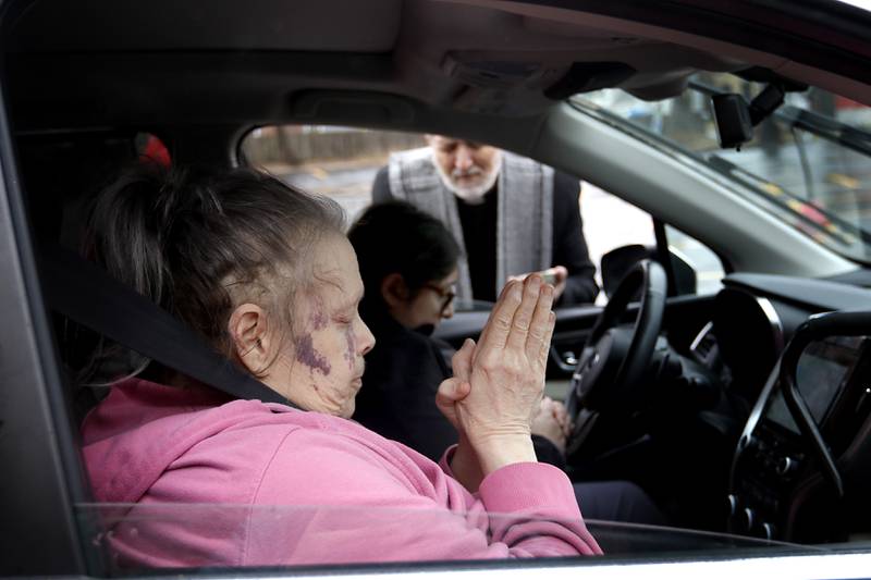 Rev. Jeffry Bross, the senior pastor at the United Methodist Church of Libertyville, prays with Mary Mulloy and Brenda Rodriguez during a Drive-Thru Ash Wednesday Blessing on Wednesday, March 05, 2025, at the United Methodist Church of Libertyville. This was the first time the church has offered a Drive-Thru Ash Wednesday Blessing, that created a simple convenient way for individuals to receive ashes and mark the beginning of the Lenten season.