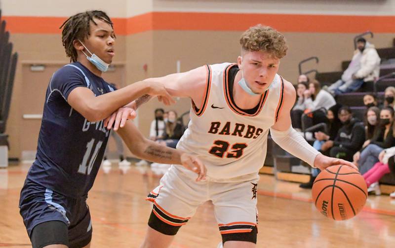 DeKalb's Lane Mcvicar (23) pushes past Guilford's Bryson Hodge (10) during the Chuck Dayton Classic in DeKalb on Wednesday, Dec. 30, 2021.