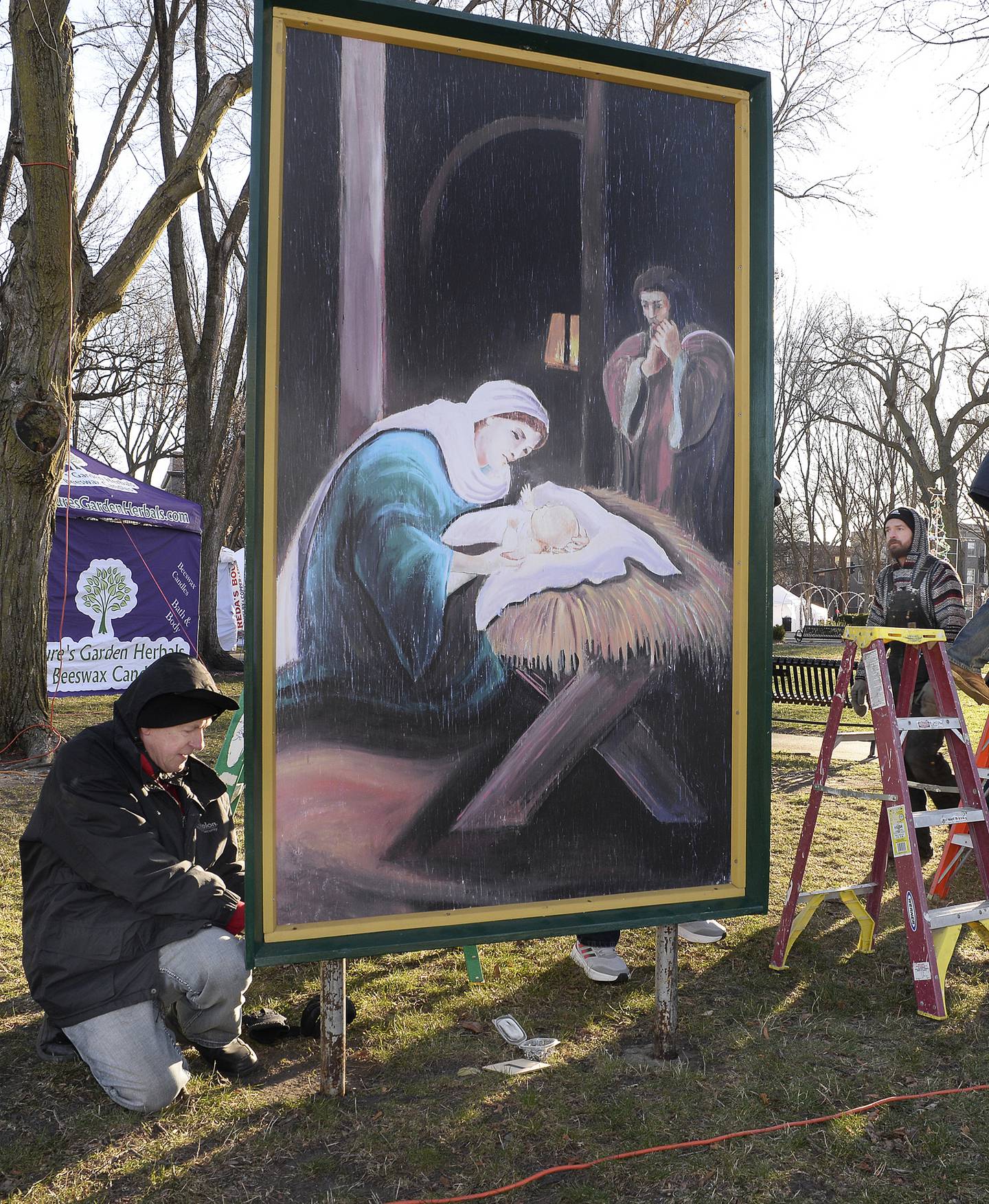Many volunteers were on hand Saturday, Dec. 3, 2022, to erect 16 large paintings of the life of Jesus Christ in Ottawa's Washington Square.