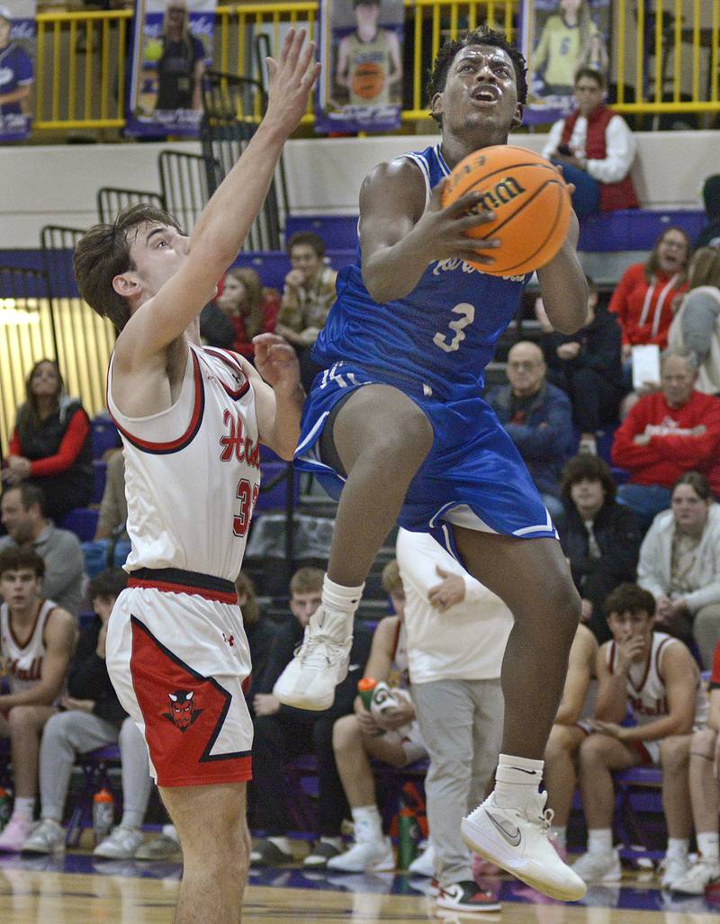 Newark’s Reggie Chapman gets up and over Hall’s Braden Curran to score late in the 2nd period Tuesday at Serena.