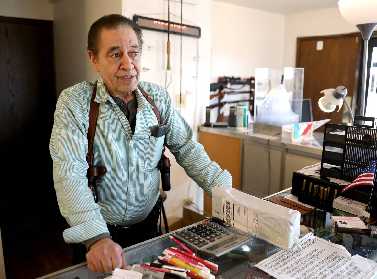 Manny Segarra of St. Charles talks about the guns and some of the ammunition no longer for sale at his store, Manny Segarra Guns in West Chicago, on Wednesday, Jan. 11, 2023. Illinois Gov. JB Pritzker signed a bill Tuesday, Jan. 10, 2023 banning the purchase, sale and manufacture of high powered semi-automatic weapons, .50 caliber rifles and ammunition, and large-capacity magazines in the state while still allowing people who already own such weapons to keep them.