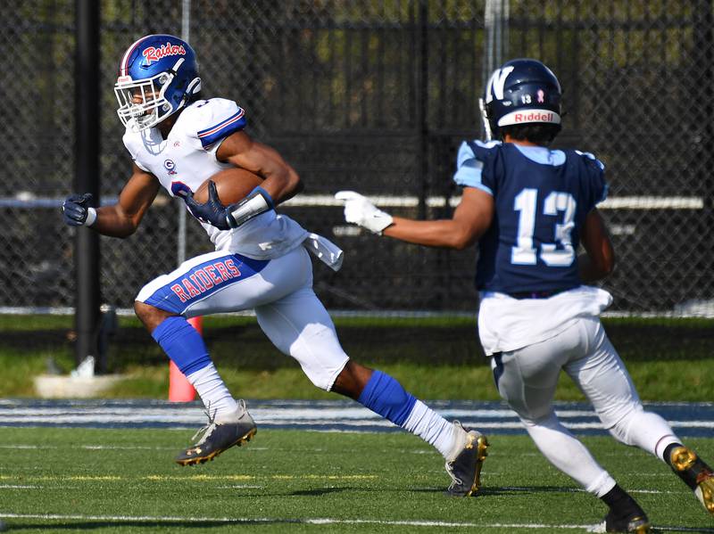 Glenbard South's Cam Williams (left) breaks away from Nazareth's Yandiel Colon (13) on a kickoff return during a Class 5A second round game on Nov. 4, 2023 at Nazareth Academy in LaGrange Park.