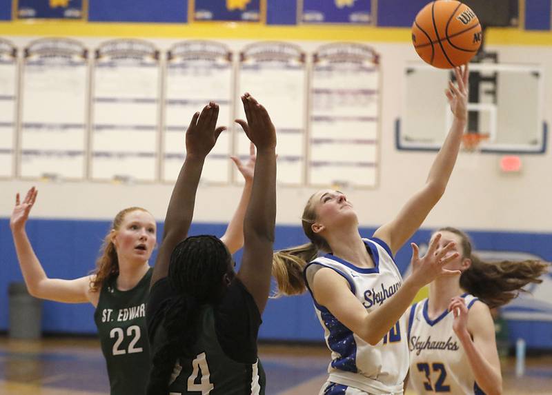 Johnsburg's Addison Sweetwood (right) shoots the ball after driving between St. Edward's Layne Dawson (left) and Sanaii McPherson (center) during the IHSA Class 2A Johnsburg Sectional girls basketball championship game on Thursday, February, 26, 2026, at Johnsburg High School.