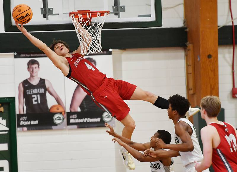 Hinsdale Central’s Vincas Buzelis (4) tries to put back his own failed dunk during a game against Glenbard West on January 31, 2025 at Glenbard West High School in Glen Ellyn.