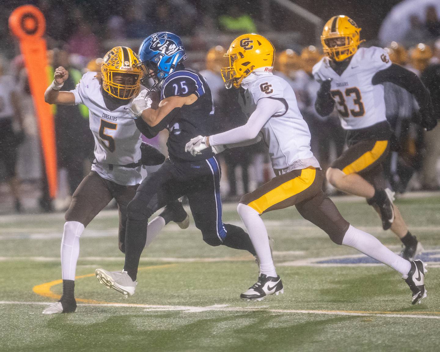 St. Charles North's Tommy Vends runs the ball for a gain as Carmel's Eli Jackson (5) and Carter Kasten (1) go for the tackle  at the Class 7A Second Round playoff game on Saturday, Nov.8,2025 in St. Charles.