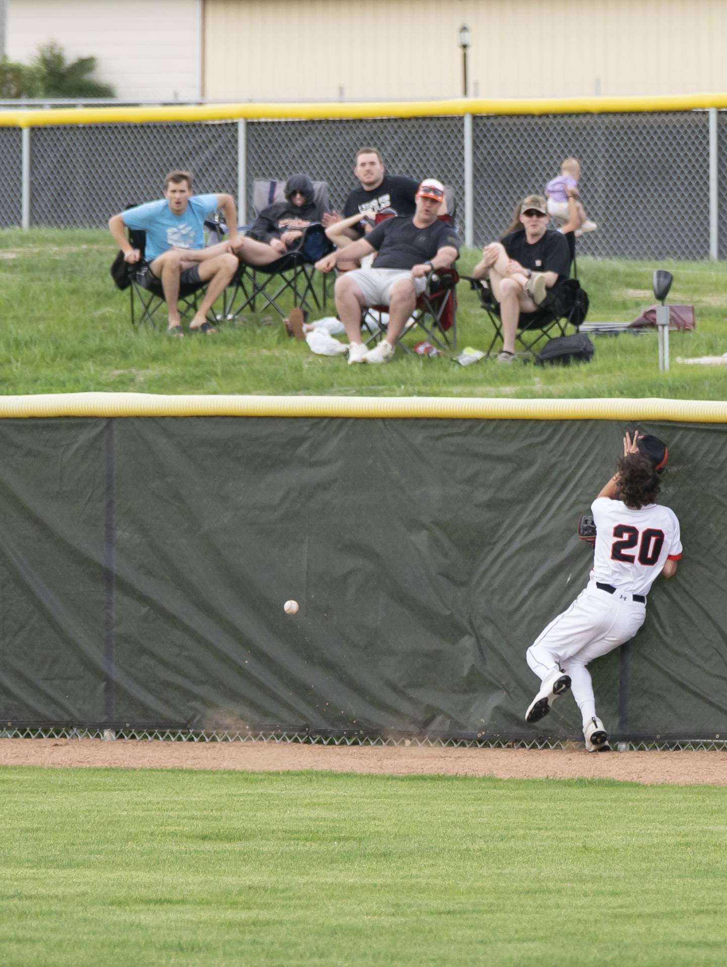 McHenry's Nathan Neidhardt collides with the fence as he tires to catch a ball in right field during their game against Prairie Ridge on Friday, May 16, 2025 at McHenry High School. Ryan Rayburn for Shaw Local
