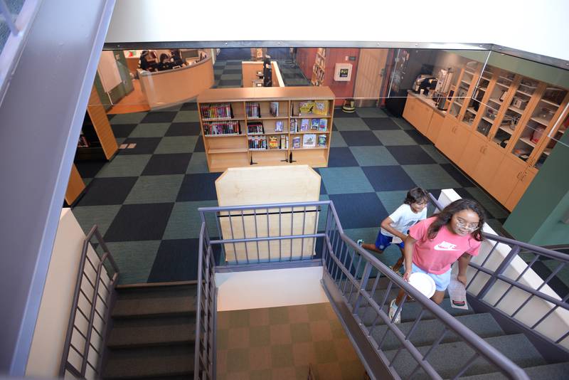Brian and Lily Garcia of La Grange Park participate in a scavenger hunt during the La Grange Park Library Grand Reopening Saturday Aug 3, 2024.