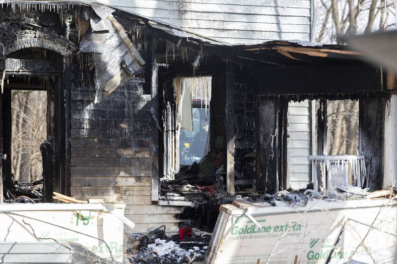 A excavator operator works to remove debris after a house fire Monday, Jan. 20, 2025, in Sterling.