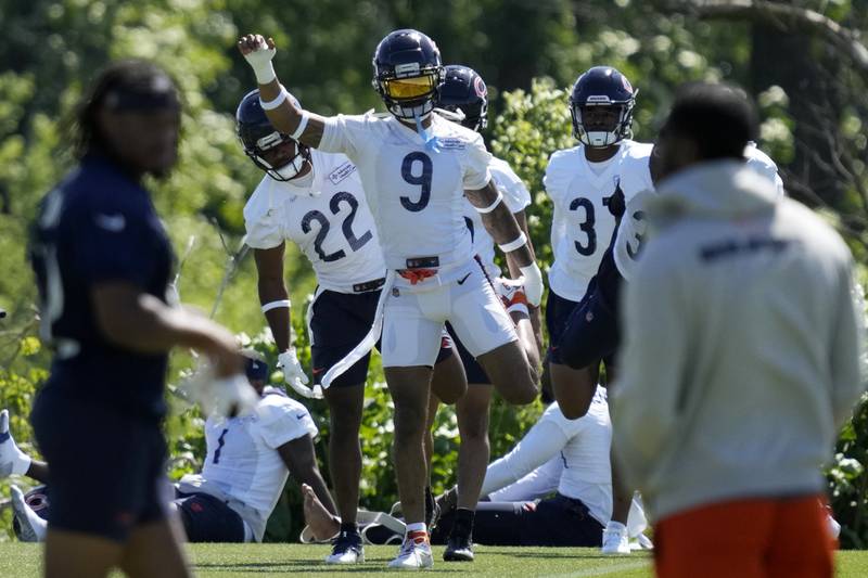 Chicago Bears safety Jaquan Brisker (9) warms up with teammates during the NFL team's mandatory minicamp football practice in Lake Forest, Ill., Thursday, June 6, 2024. (AP Photo/Nam Y. Huh)