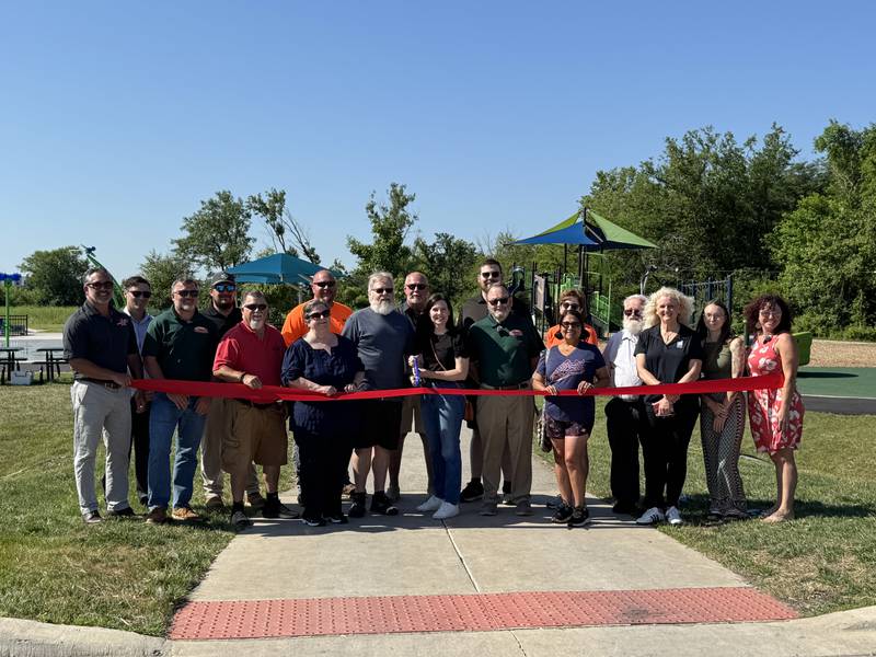 Mayor Ric Offerman along with village staff, trustees, the Davidson Family, and the Grundy/Channahon Minooka Chamber cut the ceremonial ribbon July 2 officially opening the second phase of Aux Sable Springs Park.