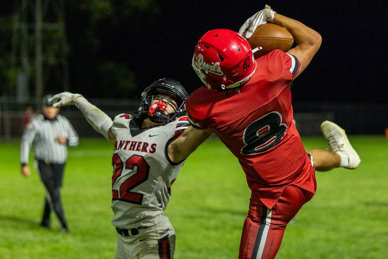 (from left) Tristan Hovey (22) of Erie-Prophetstown attempts to intercept catch from Braden Curran (8) of Hall on Friday, Sept 5, 2025 at Richard Nesti Stadium in Spring Valley.