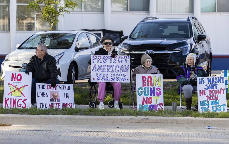 A supporter leans out of a car Friday, May 1, 2026, during a May Day protest at Central Park in Sterling. Indivisible Sauk Valley organized the gathering to continue to voice their displeasure with the Trump Administration.