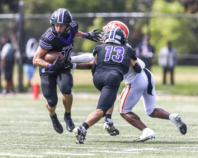Downers Grove North's Oliver Thulin (10) uses a block by Joey Serpico (13) to gain yards after a short catch during football game between Downers Grove North at Morgan Park Saturday, Aug 30, 2025  in Chicago.