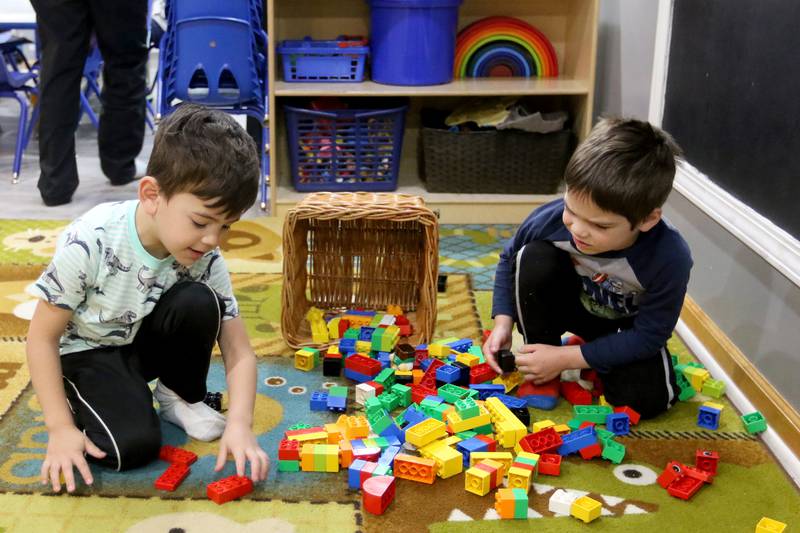 Evan Acevedo, left, and Jackson Leindecker play with building blocks Friday, April 30, 2021, at Little Hands Home Daycare and Preschool in Huntley.