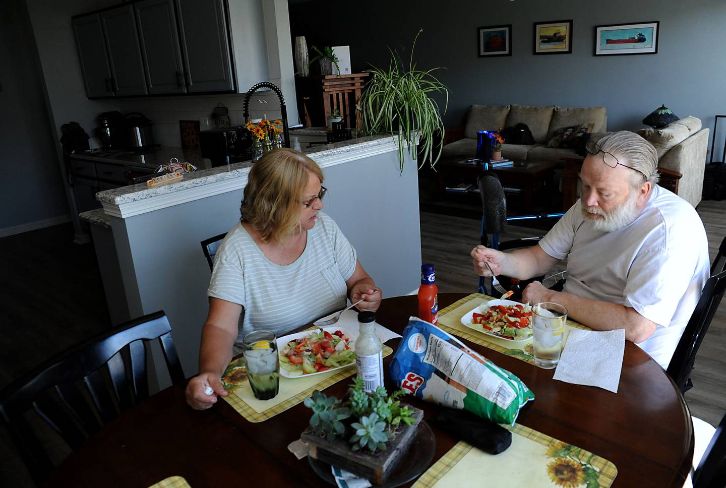 Kathy Wendhack prepares dinner for her husband, Kurt, on Tuesday, June 21, 2022, using leftover barbecue chicken and strawberries that she purchased with a digital coupon at their home in Del Webb's Sun City neighborhood in Huntley. Wendhack is trying to fight inflation by using coupons and tricks to make meals last longer.