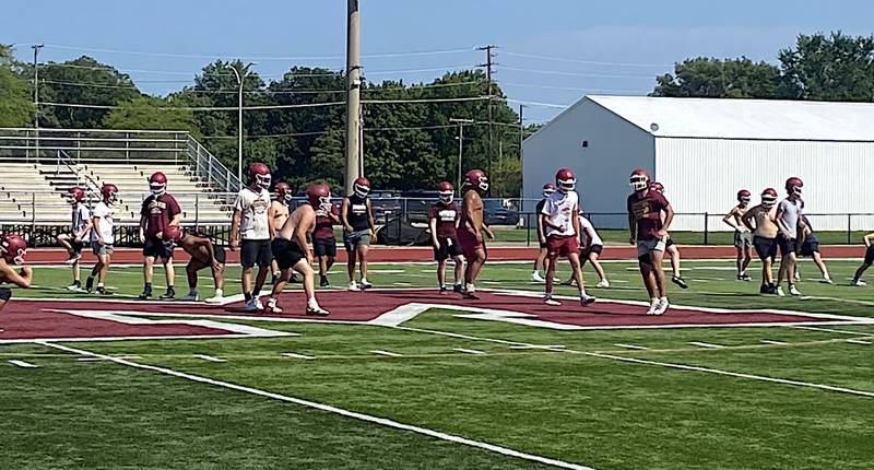 The Morris football team goes through stretching exercises during the first official practice of the season Monday.