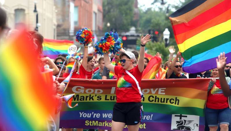 A group from St. Mark's Lutheran Church marches Sunday during the Aurora Pride parade along Downer Place.