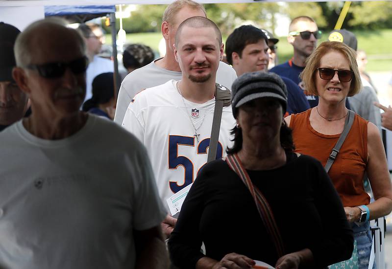 People wait in line for former Bears quarterback Jim McMahon to signs autographs and pose for pictures with customers during the grand opening of the Vertical Dispensary on Saturday, Sept. 30, 2023, in Cary. The dispensary has been open for about a month.