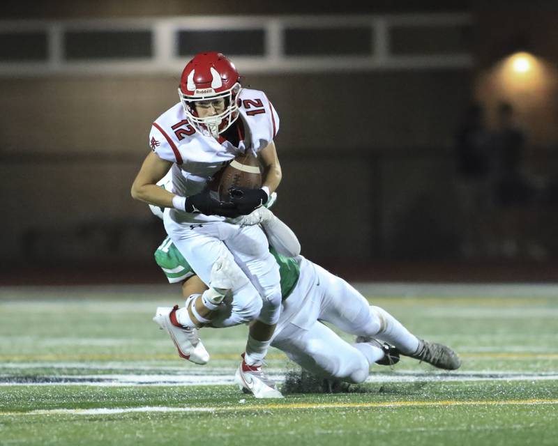 Hinsdale Central's Carter Contreras (12) fights for yards after at reception during football game between Hinsdale Central at York. Oct 8, 2021.