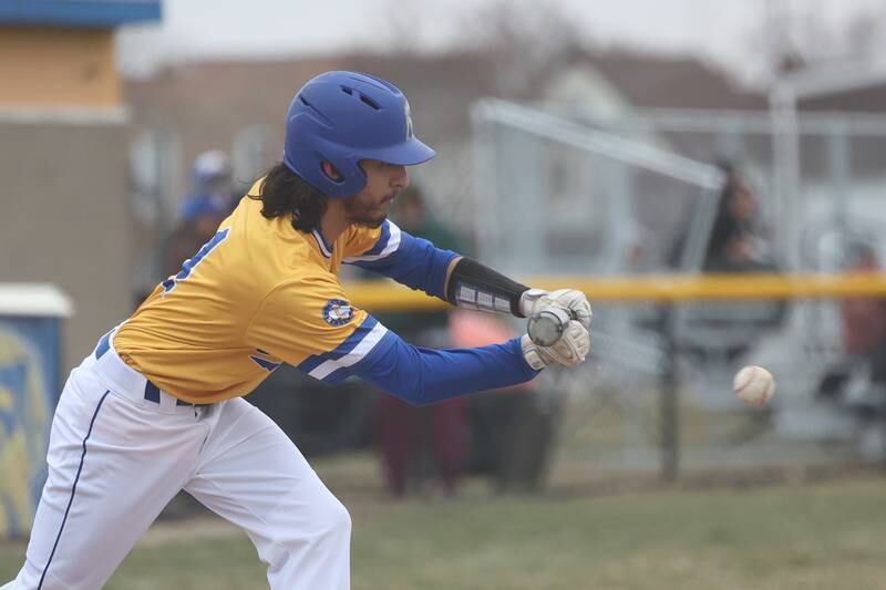 Joliet Central’s John Stasiak lays down a bunt against Bolingbrook on Tuesday, March 21st. 2023.