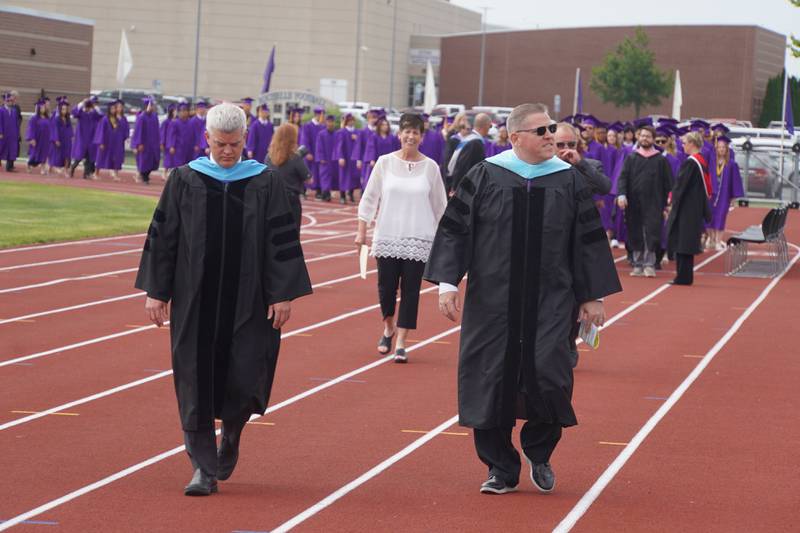 Rochelle Township High School District Superintendent Jason Harper (left) and Principal Chris Lewis lead graduating seniors to the football field on Saturday, May 23, 2026.