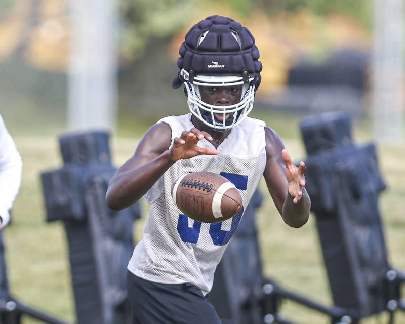 Ammar Banie receives the toss during a running play at Oswego High School Football Practice, Monday, Aug 11, 2025  in Oswego.