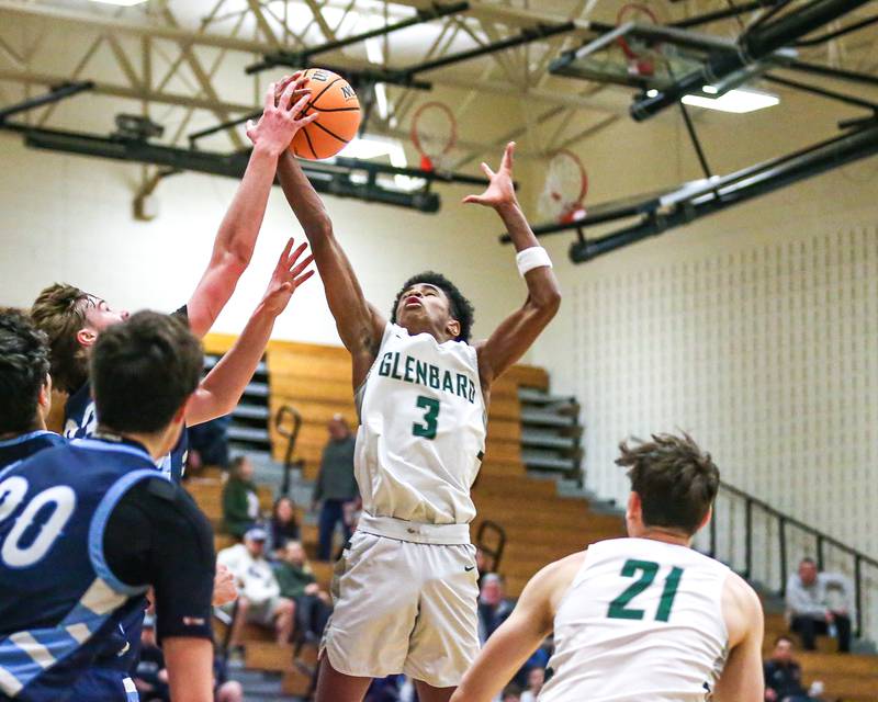 Glenbard West's TJ Williams (3) grabs a rebound during their Jack Tosh Holiday Classic basketball tournament game between Nazareth vs Glenbard West. Thursday Dec 26, 2024 in Elmhurst.