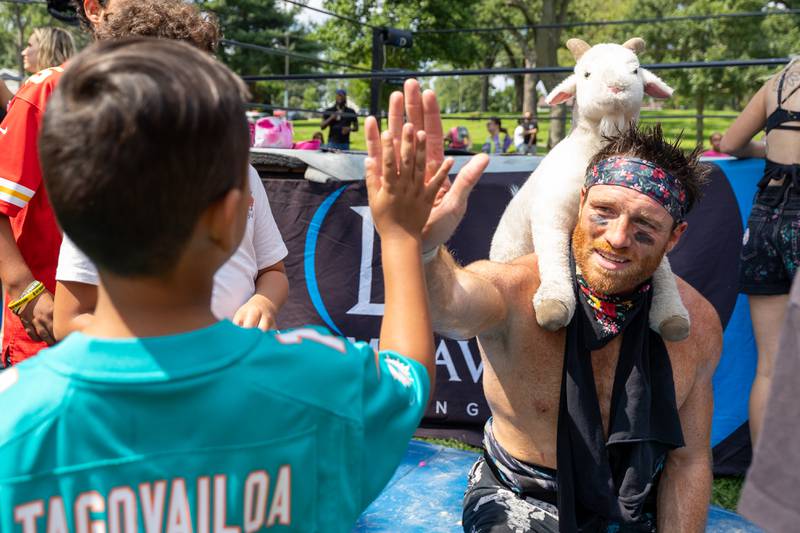 (left to right) Julian Gonzalez high fives Bobby Orlando at the Taste of the Illinois Valley DreamWave Wrestling event on Saturday, August 2, 2025 at Centennial Park in Peru.