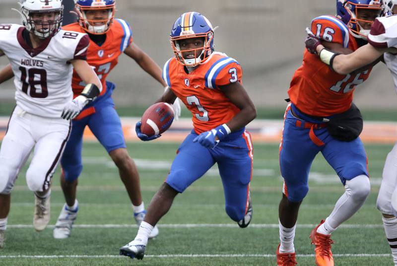East St. Louis' Christopher Bennett Jr carries the ball through the Prairie Ridge defense during their IHSA Class 6A state championship game Saturday, Nov. 26, 2022, in Memorial Stadium at the University of Illinois in Champaign.