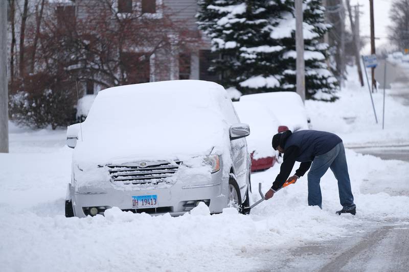 A resident shovels out his van. Many Joliet resident that stay in on Wednesday found their vehicles buried in from the snowplows working throughout the storm. Thursday, Feb. 3, 2022, in Joliet.