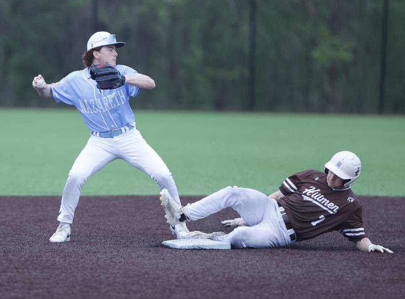 Nazareth's Gavin Hartigan (4) attempts a double play after forcing out Joliet Catholic's Steve Martin (7) during the varsity baseball game on Wednesday, April 20, 2025 between Nazareth and Joliet Catholic academies in La Grange Park.