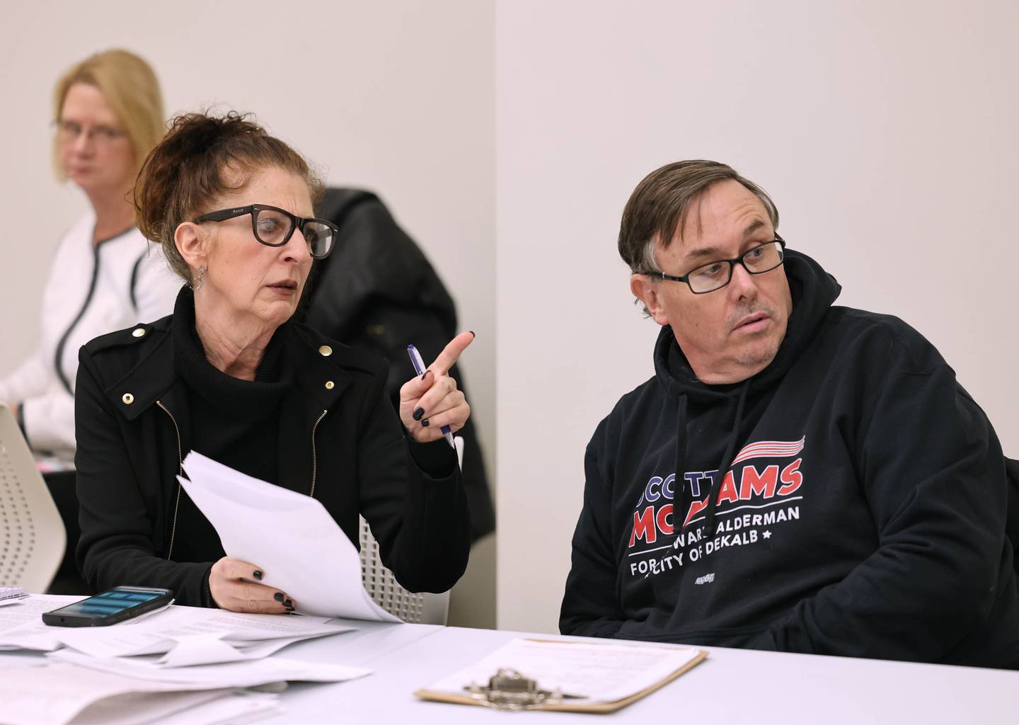 DeKalb City Council Ward 5 alderman Scott McAdams talks to his attorney Anna Wilhelmi Friday, Jan. 13, 2023, during a City of DeKalb Electoral Board hearing. The hearing was held to decide if McAdams, who is running unopposed for DeKalb’s 5th Ward aldermanic seat, should be removed from the ballot due to objections filed by two residents regarding signatures and filing procedure.