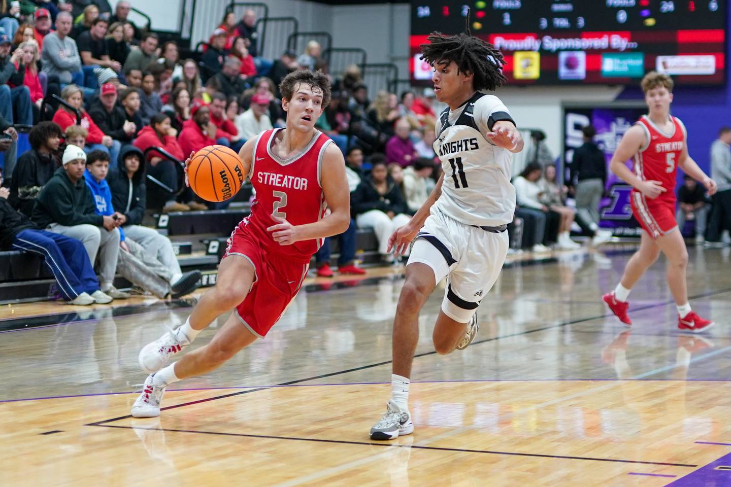 Streator's Matt Williamson (2) drives to the basket against Kaneland’s Evan Frieders (11) during a semifinal basketball game in the 61st annual Plano Christmas Classic at Plano High School last week.