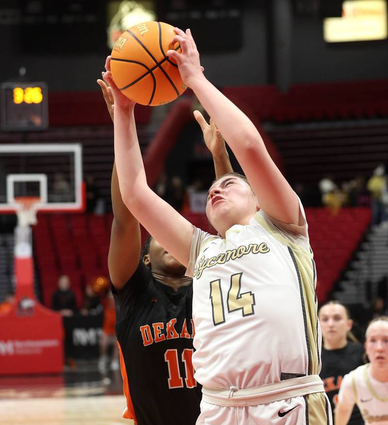 Sycamore's Norah Chami grabs a rebound in front of DeKalb's Johnna Patrick during their game Friday, Jan. 31, 2025, in the FNBO Challenge in the Convocation Center at Northern Illinois University in DeKalb.