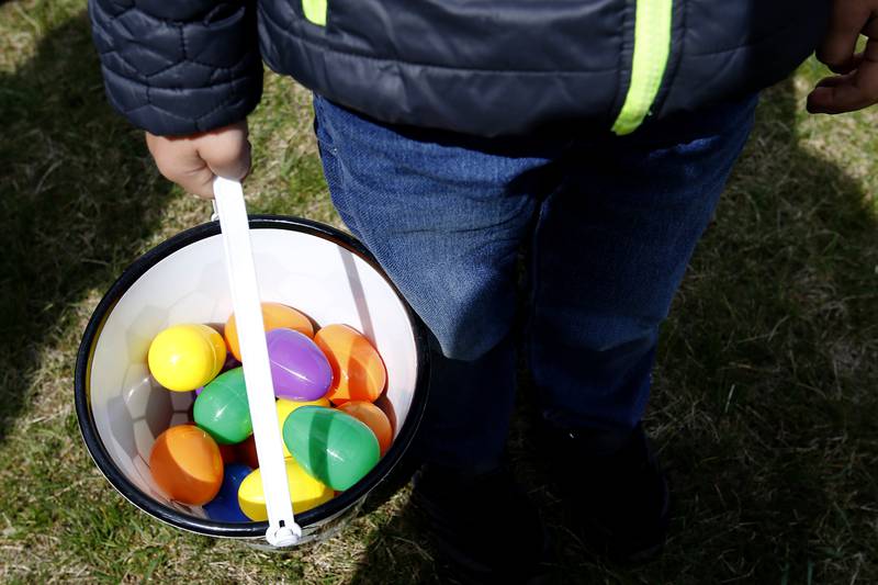 Vinny Puccio, 3 1/2, holds his bucket of eggs on Saturday, April 19, 2025, during the Johnsburg Easter Egg Hunt at Sunnyside Memorial Park, in Johnsburg. Children hunted for 6,000 candy-filled eggs in three hunts divided by age group.