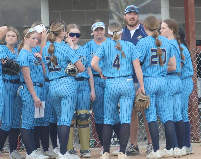 Marquette head softball coach Brian McCallum talks to his team between innings while playing Mendota on Wednesday, March 25, 2026 at June Gross Field in Ottawa.