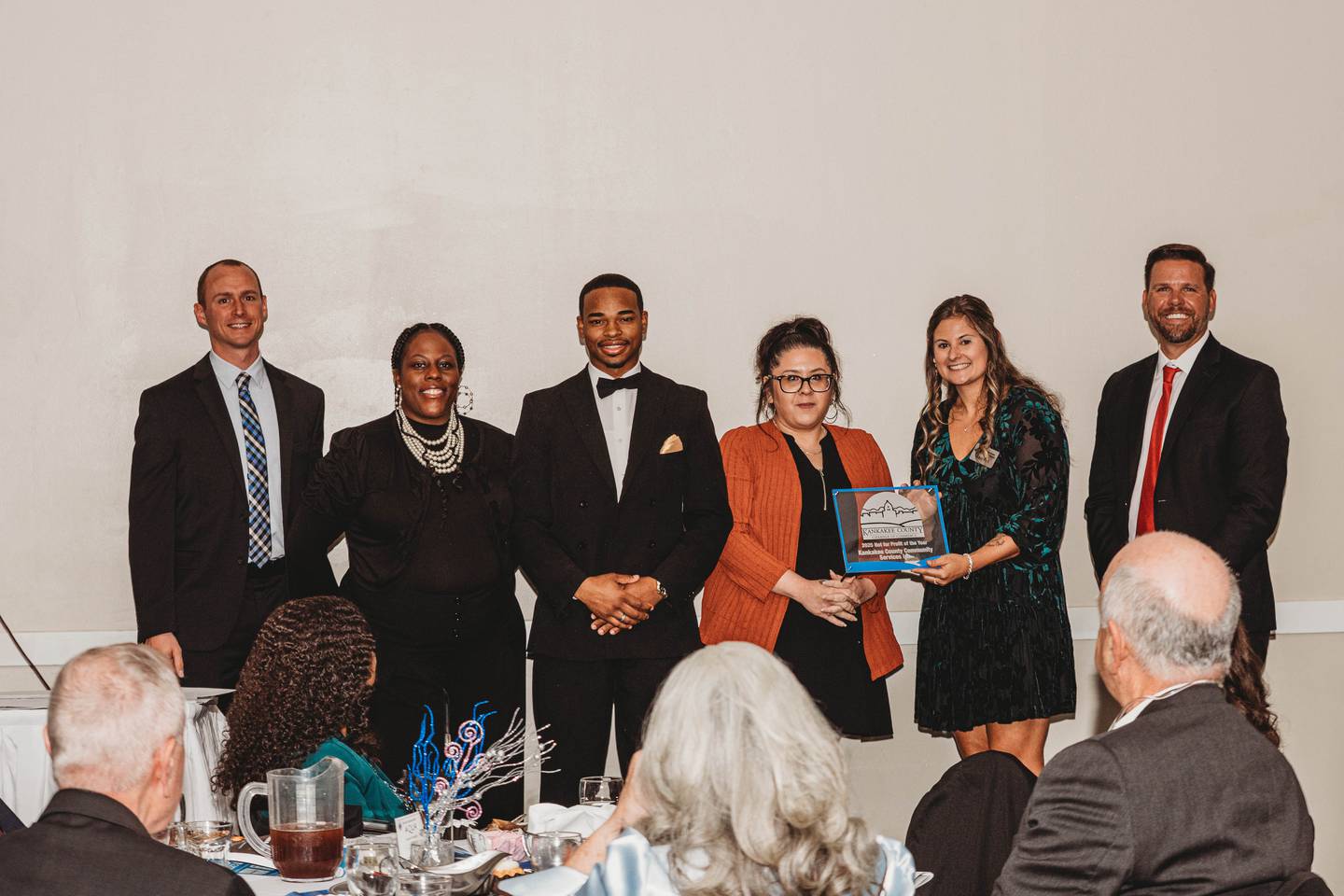 Representatives of Kankakee County Community Services, Inc., accept the Not-For-Profit of the Year Award from Kankakee County Chamber of Commerce president and CEO Kelsey Post, second from right, vice chair Matthew Schore, right, and chair Rob Warmbir, left, during the chamber's annual Gala & Awards on Thursday, Nov. 6, 2025.