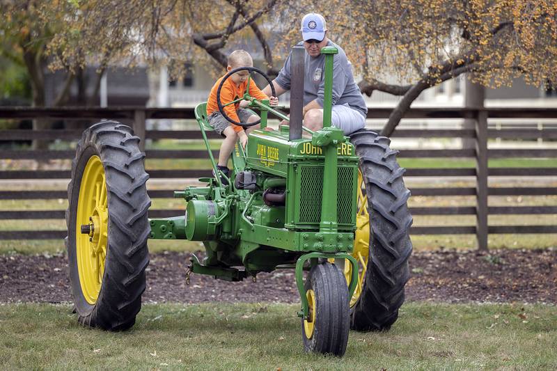 Andrew Derrig and Jack, 4, of Grand Detour check out one of several classic John Deere tractors on display at the John Deere Historic Site’s Fall Fest on Saturday, October. 12, 2024.