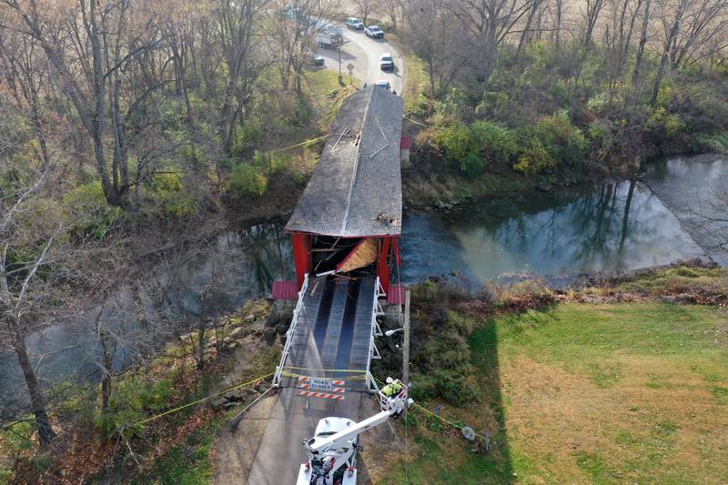 An aerial view of the damage of the Red Covered Bridge on Thursday, Nov. 16, 2023 in Princeton. Illinois Department of Transportation, Illinois State Police and Bureau County law enforcement survey the damage bridge after it was struck by a semi-truck.