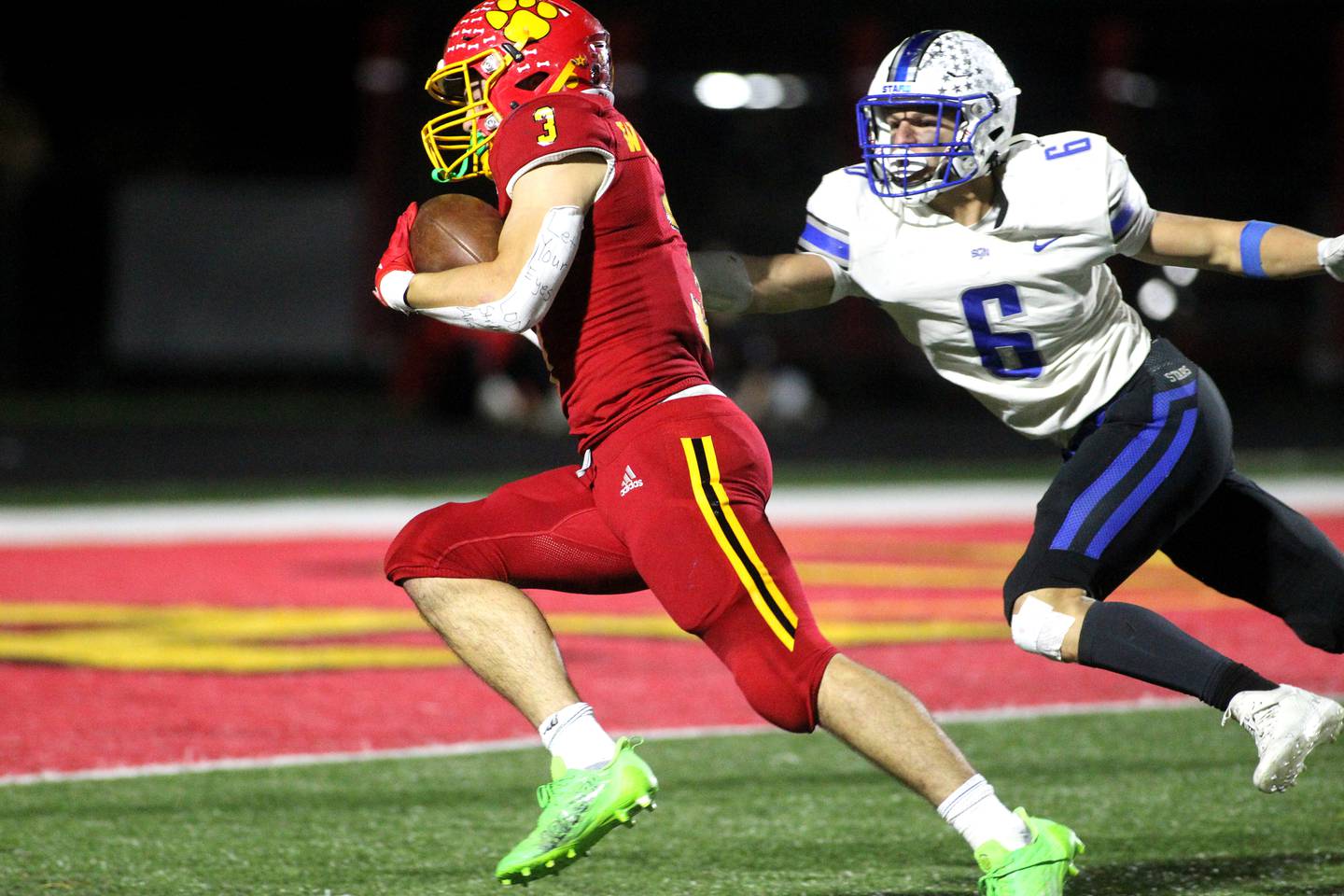 Batavia’s Ryan Whitwell (3) gets away from St. Charles North’s Drew Surges to score a touchdown in the second quarter during a game at Batavia on Friday, Oct. 21, 2022.