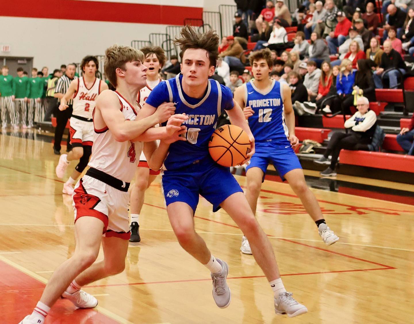 Hall's Luke Bryant defends Princeton's Gavin Lanham at the Colmone Classic on Friday night.