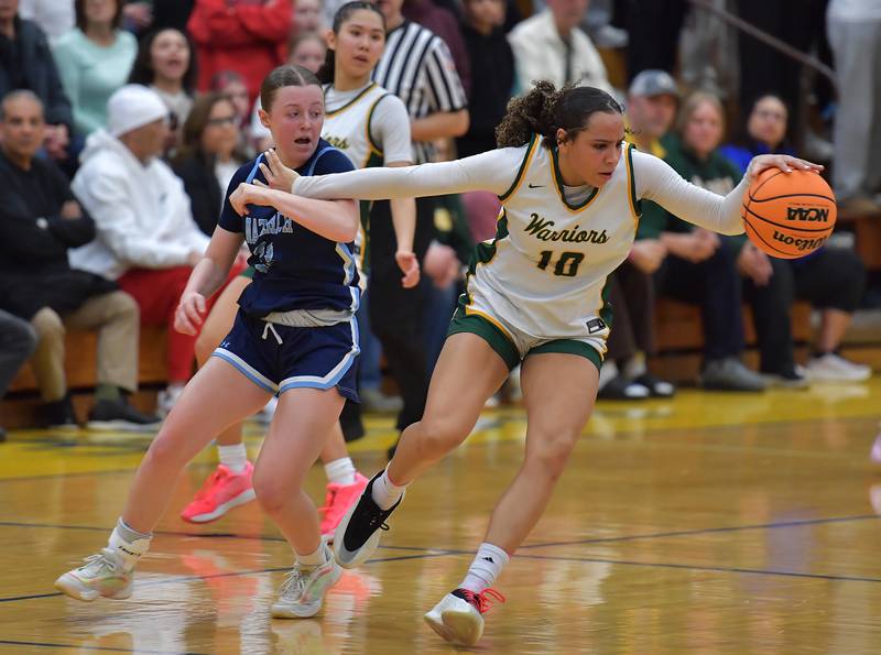 Waubonsie Valley’s Danyella Mporokoso (10) grabs loose ball as she holds of Nazareth’s Molly Moore during the Class 4A Lyons Supersectional game on March 2, 2026 at Lyons Township High School in LaGrange.