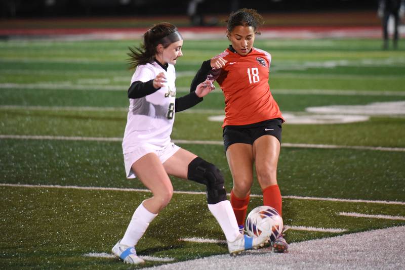Bradley-Bourbonnais' Nia Lawrence, right, looks to make a pass as Bishop McNamara's Isabelle Kuntz defends during a game at Bradley-Bourbonnais Tuesday, April 1, 2025.