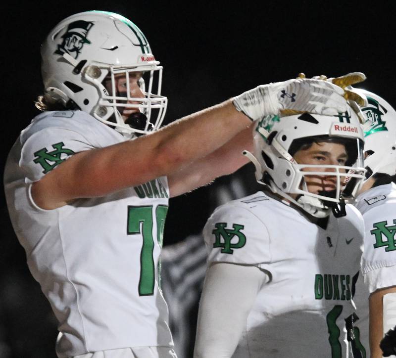 York’s Bruno Massel, right, celebrates his first quarter touchdown against Naperville Central with teammates including Joe Reiff during the Class 8A football state semifinal on Saturday, Nov. 23, 2024 in Naperville.