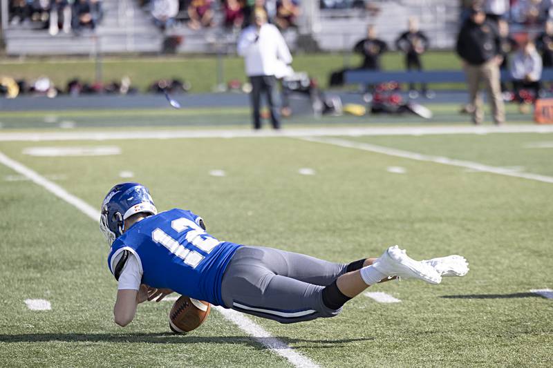 Newman’s Evan Bushman dives on a high snap on the first play of the game against ROWVA Saturday, Oct. 28, 2023 in the Class 1A playoffs in Sterling.