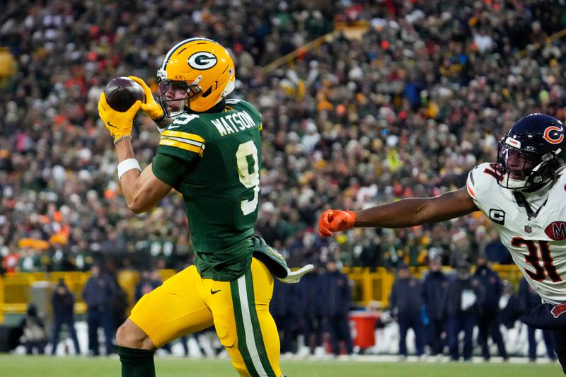 Green Bay Packers wide receiver Christian Watson (9) runs to score a touchdown against Chicago Bears safety Kevin Byard III (31) during the first half of an NFL football game, Sunday, Dec. 7, 2025, in Green Bay, Wis. (AP Photo/Morry Gash)