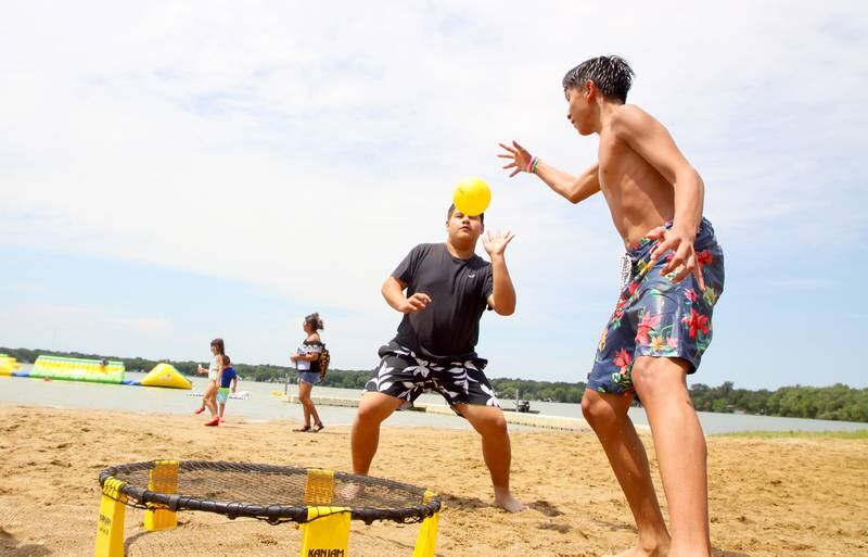 Josue DeLaRosa, right, 14, plays Spike Ball with friend  Kevin Ochoa, 14, on the beach at McCullom Lake during Fiesta Days at Petersen Park in McHenry Sunday.