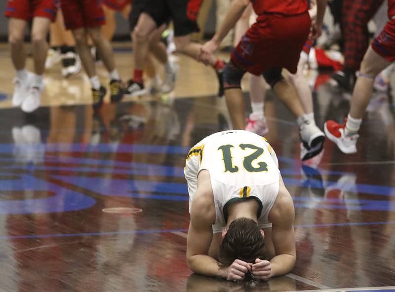 Crystal Lake South's Cooper LePage kneels on the floor after he missed a three-point shot to loose to Marmion in the final seconds of a IHSA Class 3A Sectional boys basketball game Tuesday, Feb. 28, 2023, at Central High School in Burlington.