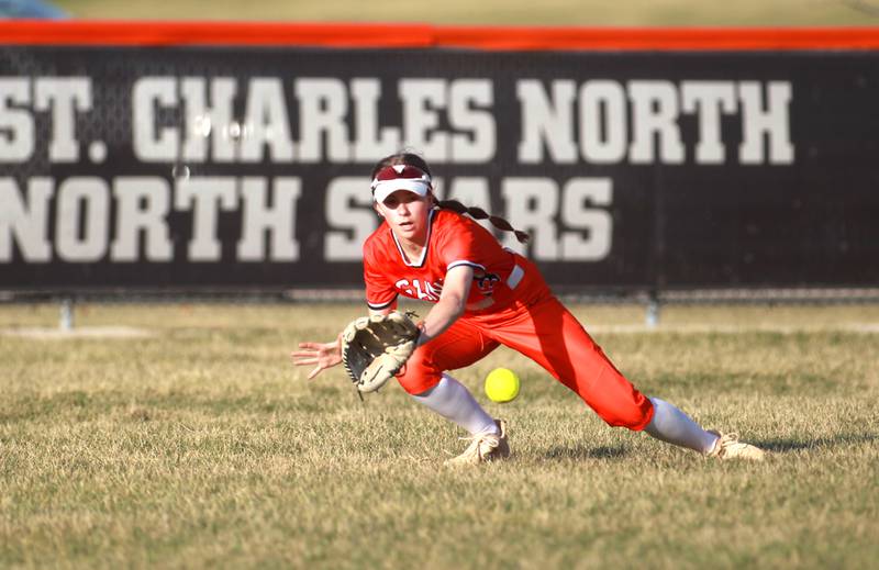 St. Charles East's Morgan Beers tries to stop a ball in center field during a game against Downers Grove North on Friday, March 28, 2025 in St. Charles.