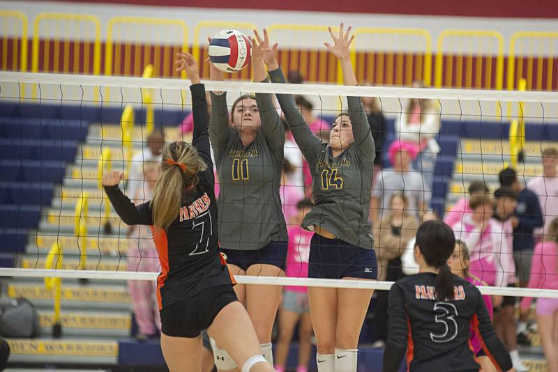 Sterling’s Kathryn Rowzee (left) and Sterling’s Maggie Rowzee go up to block a shot against United Township’s Marisah Holland Thursday, Oct. 6, 2022.